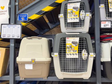 Ljubljana, Slovenia - October 02, 2025: Pet carriers arranged on a shelf in a store, featuring different sizes and colors for safe pet transportation