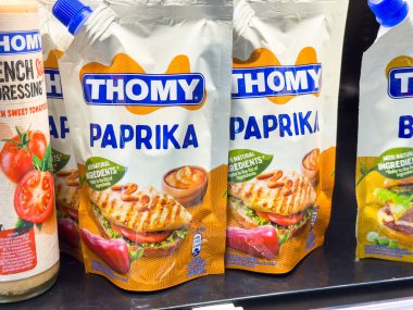 Ljubljana, Slovenia - October 02, 2025: Thomy Paprika seasoning packets are prominently displayed on a supermarket shelf, highlighting their vibrant colors and natural ingredients