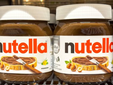 Ljubljana, Slovenia - October 02, 2025: Nutella jars are prominently featured on a shelf, highlighting the rich chocolate spread with hazelnuts and bread