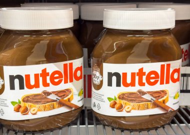Ljubljana, Slovenia - October 02, 2025: Nutella jars filled with creamy hazelnut spread are arranged on a grocery store shelf, inviting indulgence