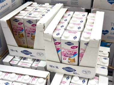 Ljubljana, Slovenia - October 02, 2025: Stacked cartons of Pomurska light milk in warehouse, highlighting dairy products in neat arrangement for retail display