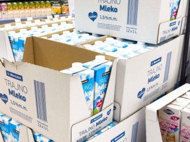 Ljubljana, Slovenia - October 02, 2025: Trajno Mleko milk cartons are neatly arranged in a grocery store, highlighting the product's branding and packaging