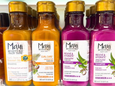 Ljubljana, Slovenia - October 02, 2025: Maui Moisture Hair Care products include shampoo and conditioner bottles on a shelf, showcasing vibrant packaging for hair hydration