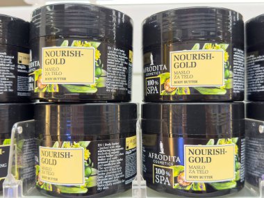 Ljubljana, Slovenia - October 02, 2025: Nourish-Gold body butter jars by Afrodita Cosmetics are beautifully arranged, highlighting premium skincare for hydration and nourishment