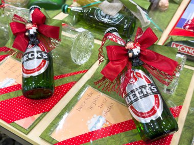 Ljubljana, Slovenia - October 02, 2025: Beck's beer bottles are beautifully adorned with red bows and figurines, creating a festive atmosphere for holiday gifting