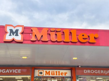 Ljubljana, Slovenia - October 02, 2025: Muller retail store exterior features bold signage and inviting design, creating a lively atmosphere for shoppers