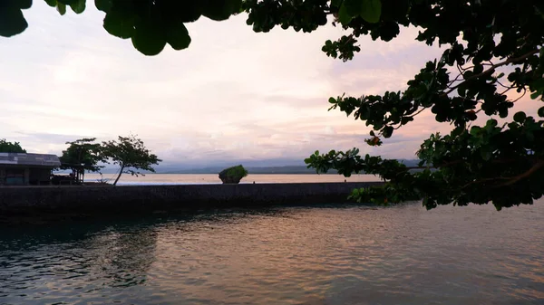 Afternoon sea view and sea-wall, beach, and coral, sunset background on Santolo beach Indonesia