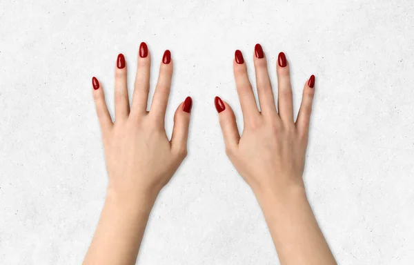 Cosmetic and makeup. Beauty delicate hands with manicure closeup. Beautiful female fingers with red manicure. Beautiful nails closeup, great idea for the advertising of cosmetics