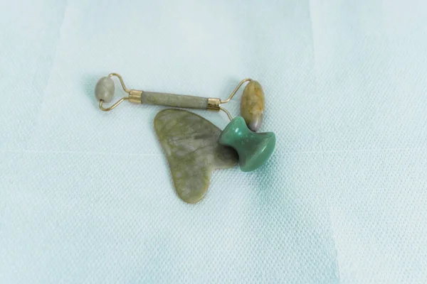 Yüz masajı ve yüz gerdirme için yeşim taşı ve gua sha kapatın.