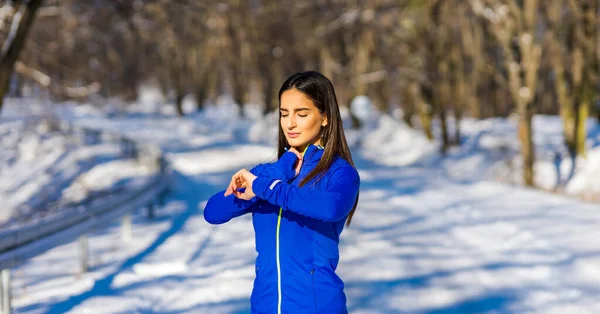 Spor giyim sektöründe güzel bir beyaz kadın akıllı saatini ne zamandır çalıştığına ve ne kadar kalori yaktığına bakar..