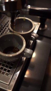 Kahve makinesi taze demlenmiş espresso dolduruyor.