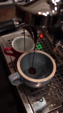 Kahve makinesi taze demlenmiş espresso dolduruyor.