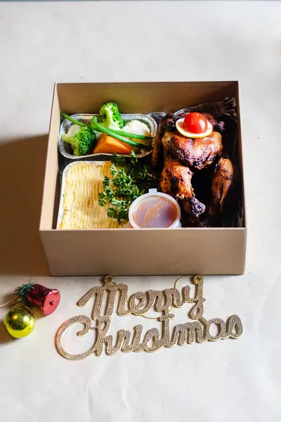 Kızarmış tavuk, sebze, patates püresi ve sosla süslenmiş Noel yemeği kutusu ve 
