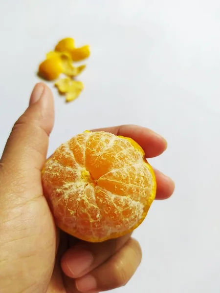Peeled ripe yellow oranges isolated on white background