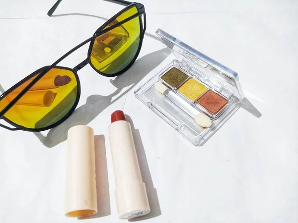Sunglasses, lipstick, eyeliner, eyeshadow, isolated on white background, makeup tools