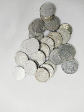 Collection of Indonesian rupiah coins on a white background