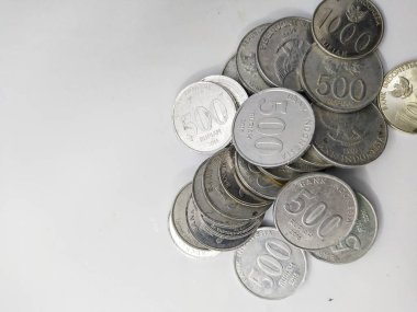 Collection of Indonesian rupiah coins on a white background