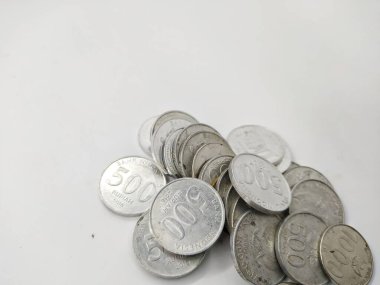 Collection of Indonesian rupiah coins on a white background