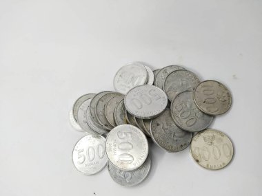 Collection of Indonesian rupiah coins on a white background
