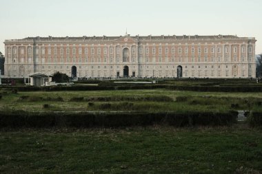 The entire facade of the Royal Palace of Caserta, seen from the gardens of Piazza Carlo di Borbone.