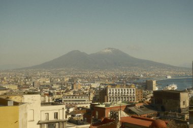 Vesuvius, Naples and the Port of Naples seen from Corso Vittorio Emanuele. Photo taken with a film simulation that recalls the 1970s.