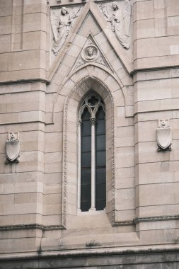 Gothic mullioned window on the left of the facade of the Cathedral of Santa Maria Assunta in Via del Duomo in Naples.