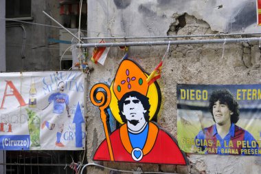 Diego Armando Maradona dressed as San Gennaro, the patron saint of the city of Naples. Artistic work placed in Largo Maradona in the Spanish Quarters of Naples. clipart