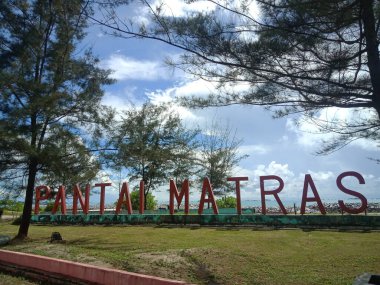 Sungailiat, Bangka, Indonesia. July 15, 2022. colored Pantai Matras icon writing on Matras beach, Bangka Island