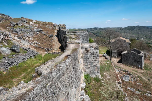 Inner wall of the castle and old walled village of Ansiaes in Portugal with the Church of Sao Salvador in the background
