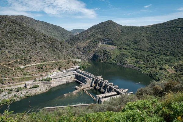 stock image Between hills and mountains the river Douro and in the background the hydroelectric dam of Valeira in Tras os Montes, Portugal