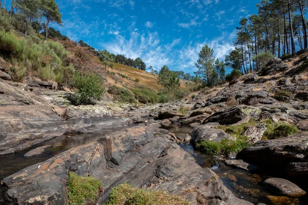 stock image Watercourse along the mountain descending the rocks below at Fisgas de Ermelo in Serra do Alvao in Portugal