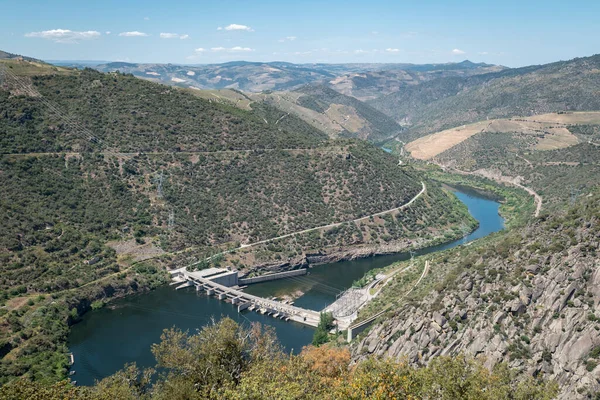 stock image Between hills and mountains the river Douro and in the background the hydroelectric dam of Valeira in Tras os Montes, Portugal