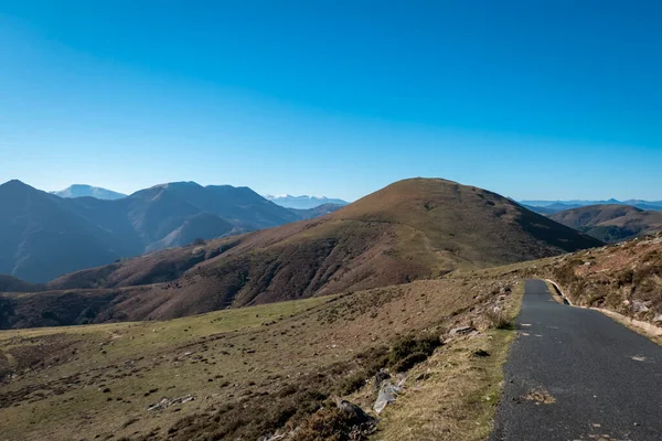 stock image Access road to the top of the Artzamendi mountain in the Basque Country in France, with more mountains in the background