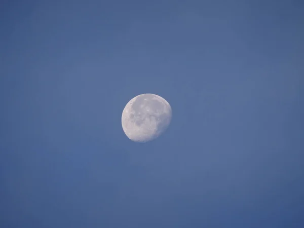 Morning with a full moon on a blue sky background