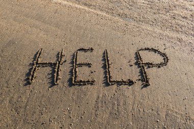 Word of Help or Help drawn in the sand