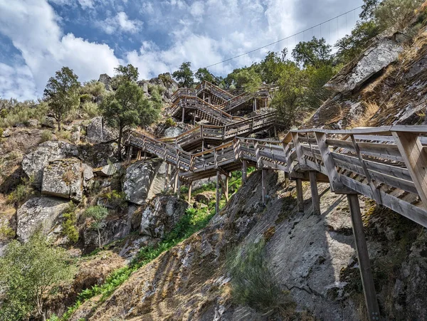 stock image Between hills and rocks, the Paiva walkways next to the Paiva river in Arouca, with the cables at the bottom of the suspension bridge in Portugal