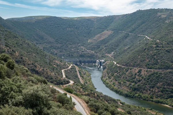 Tepeler ve dağlar arasında, arkada Douro Nehri ve Portekiz 'deki Valeira hidroelektrik barajı.