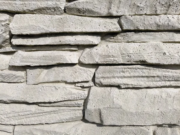 Wall with stones in a pile with joints between them