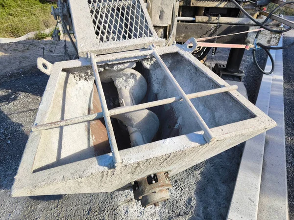 Concrete paving machine on a construction site. Box where the cement is stored.