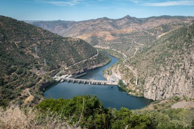 Tepeler ve dağlar arasında, Douro nehri ve arka plandaki Valeira hidroelektrik barajı Tras os Montes, Portekiz 'de.