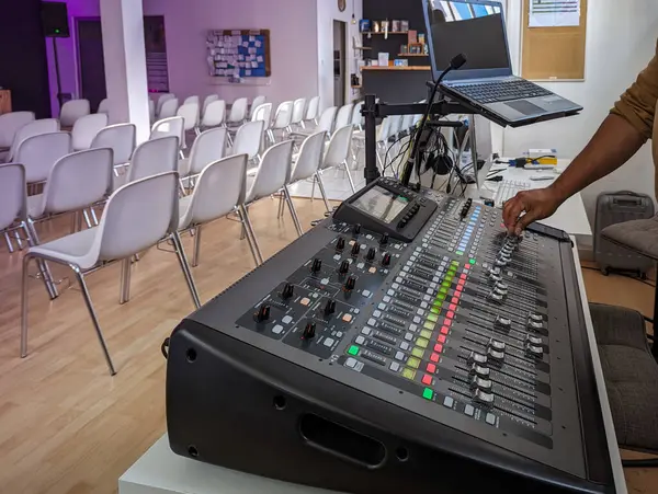 stock image Soundboard in an auditorium with a sound professional making the necessary adjustments