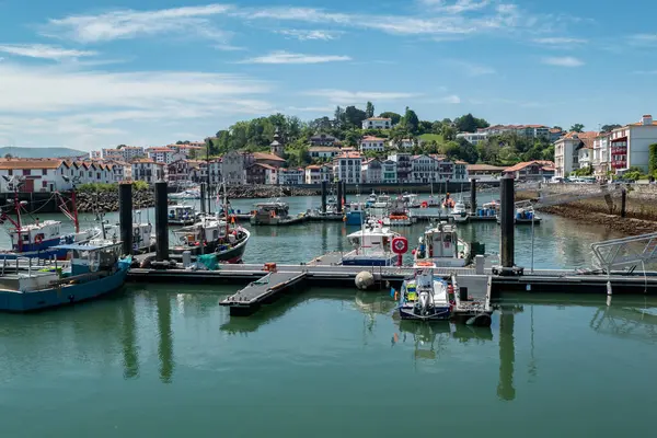 stock image Picturesque view over the port of Saint Jean de Luz with some boats anchored with part of the city in the background, in the French Basque Country