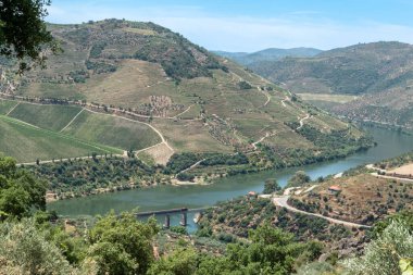 In the middle of mountains, the Douro River with a bridge where the train passes in Tras os Montes, Portugal