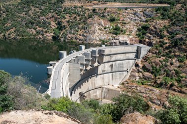 Amidst mountains, the hydroelectric dam on the Tua river for energy production, in Tras os Montes, Portugal clipart