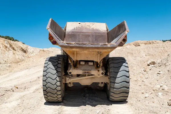 stock image Rear view of a large dump truck working in a quarry on shitting and transporting earth