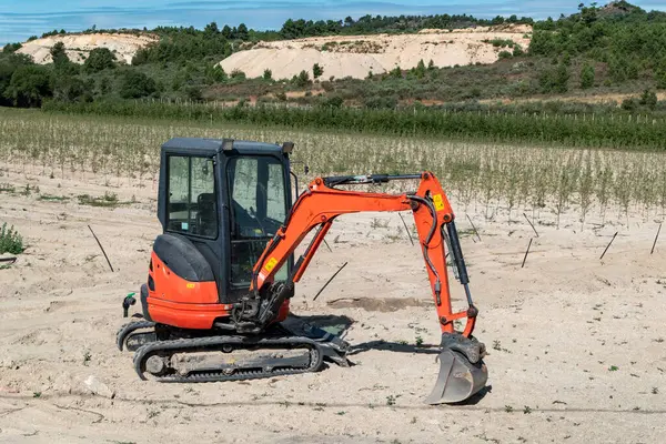 stock image Small tracked backhoe in a rural environment at planting, irrigation and earthmoving work