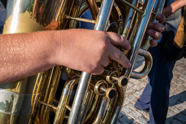 Musical band with musician playing tuba amid popular festival procession