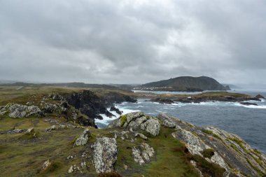 The coast of Punta Frouxeira in Galicia, Spain, a spectacle of nature under a turbulent sky clipart