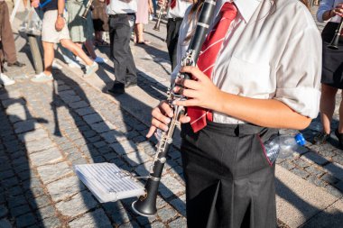 Orchestra with wind instruments livening up the procession in a traditional Portuguese pilgrimage clipart