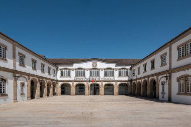 Mogadouro Town Hall with the flying flags of Mogadouro, Portugal and the European Union, a historic building in the center of the town in Portugal clipart